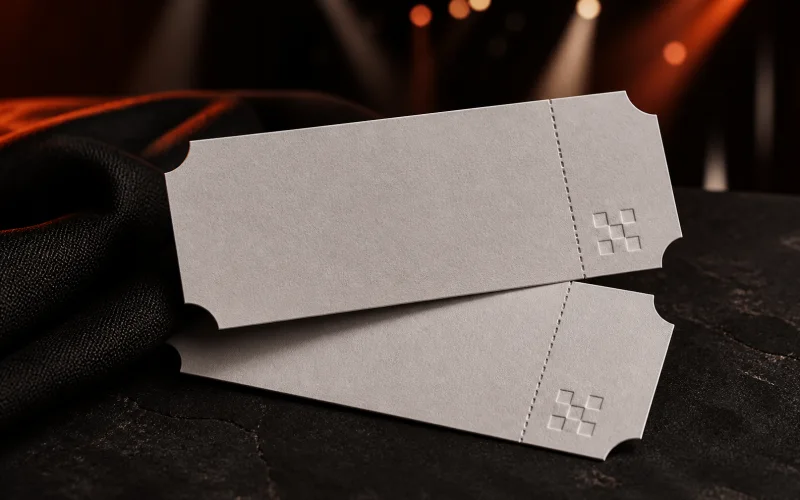 Two blank premium admission tickets with subtle checker embossing